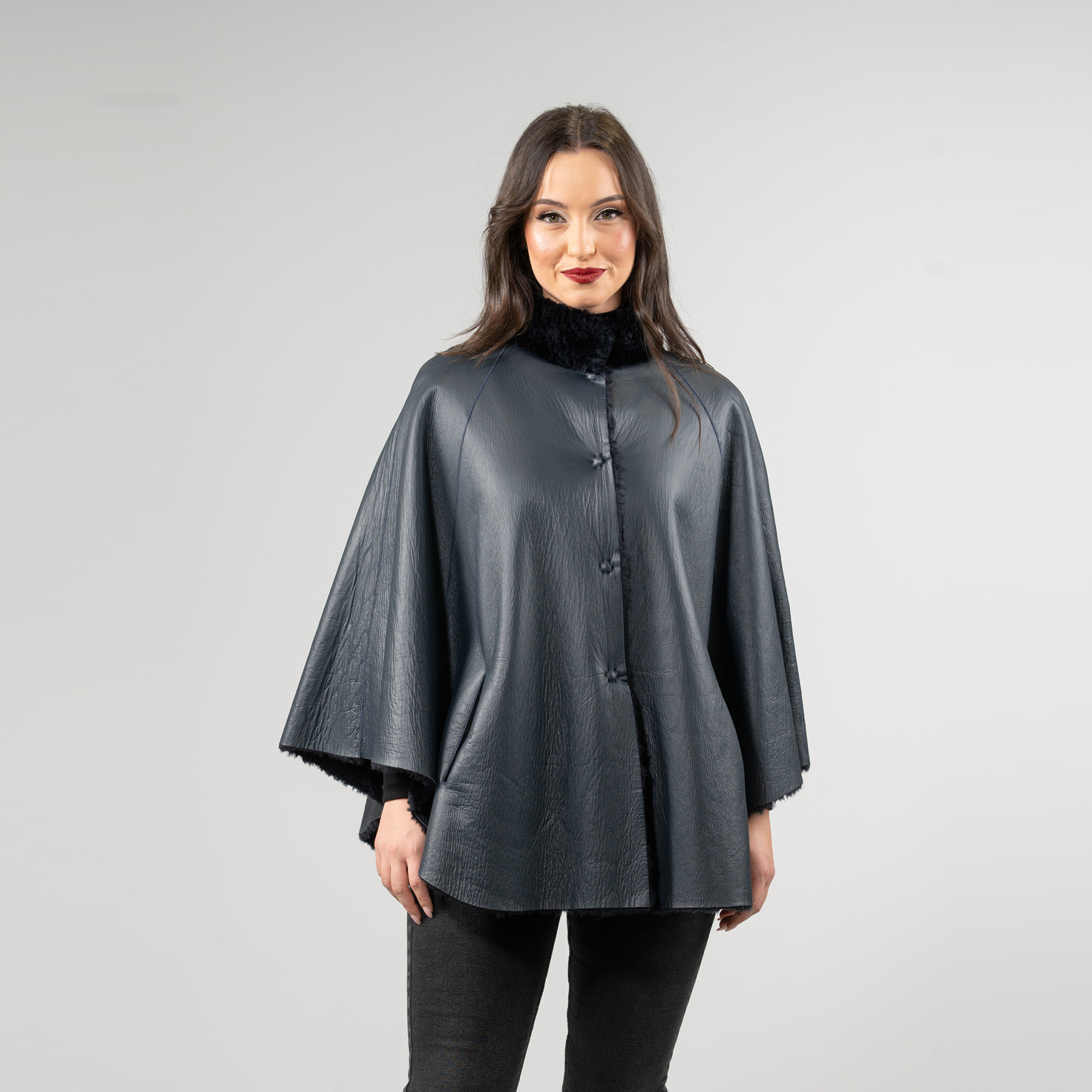 Reversible sheepskin cape in blue color