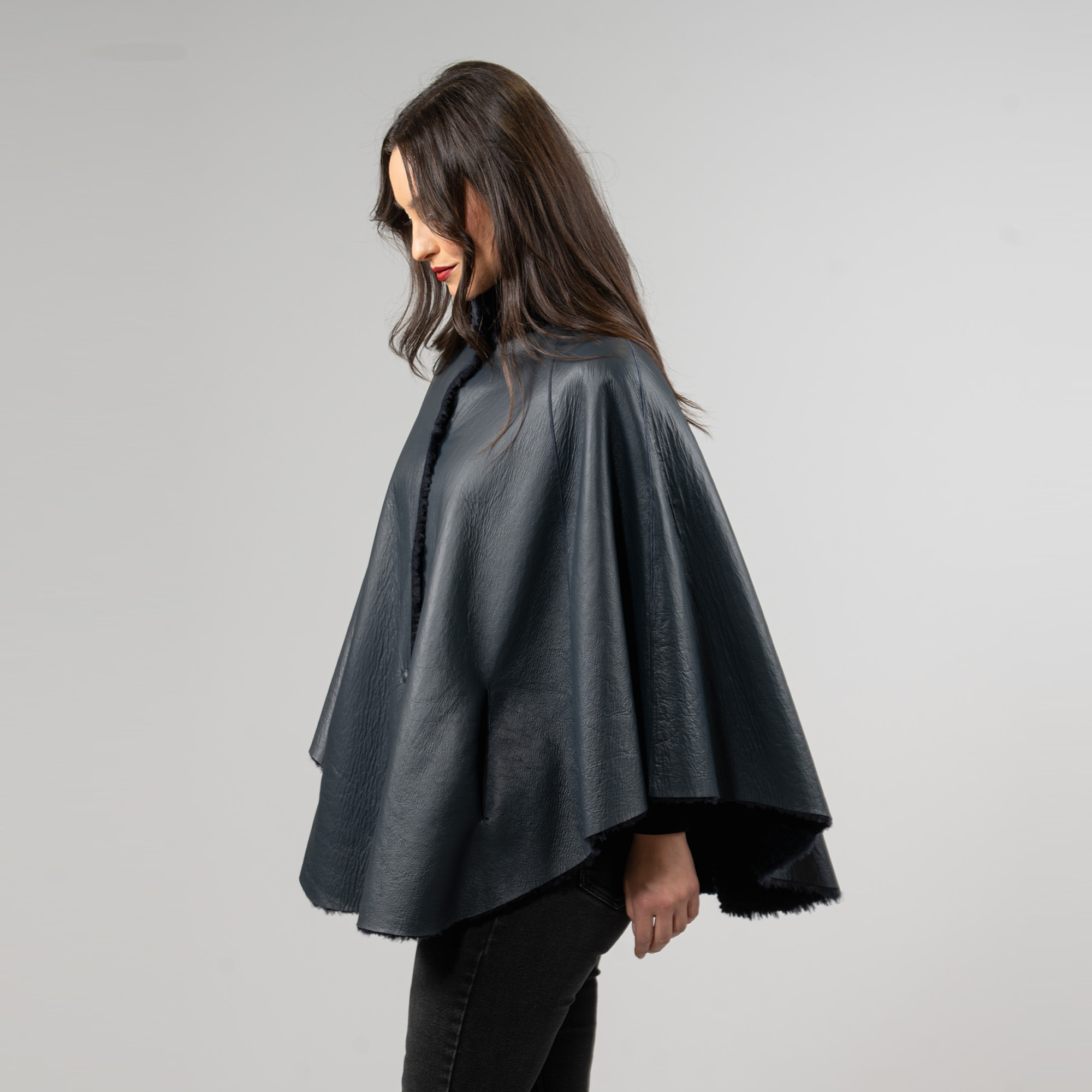 Reversible sheepskin cape in blue color