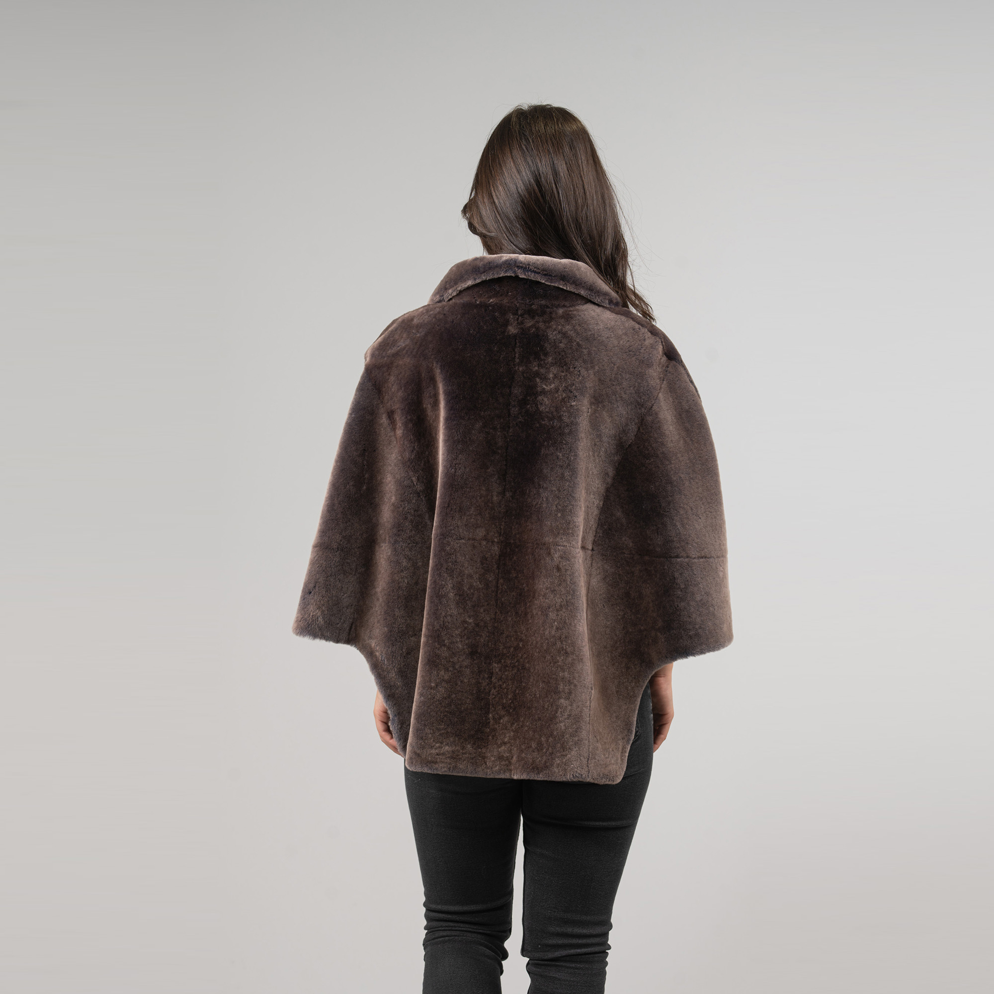 Sheepskin cape in brown color